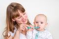 Mother and her baby brushing teeth together Royalty Free Stock Photo