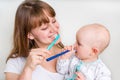 Mother and her baby brushing teeth together Royalty Free Stock Photo