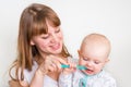 Mother and her baby brushing teeth together Royalty Free Stock Photo