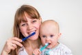 Mother and her baby brushing teeth together Royalty Free Stock Photo