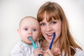 Mother and her baby brushing teeth together Royalty Free Stock Photo