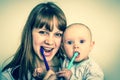 Mother and her baby brushing teeth together - retro style Royalty Free Stock Photo