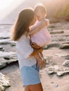 Mother with her baby girl on ocean beach. Mother's love for child Royalty Free Stock Photo