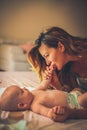 Mother and her baby at morning . Side view. Royalty Free Stock Photo