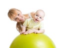 Mother and her baby having fun with gymnastic ball Royalty Free Stock Photo