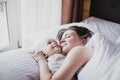 Mother and her baby playing in bed. Happy family concept. Royalty Free Stock Photo