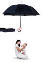 Mother and her baby sitting under umbrella Royalty Free Stock Photo