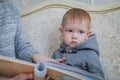 Mother and her baby son looking photobook