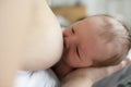 Mother in her bedroom breastfeed her baby.