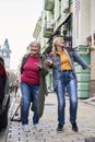 Mother and her cheery daughter joking and fooling around