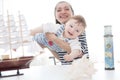 Mother and her child boy making model ship. Royalty Free Stock Photo