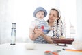 Mother and her child boy making model ship. Royalty Free Stock Photo