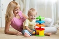 Mother and her child playing with colorful logical toy Royalty Free Stock Photo