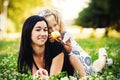 Mother and her child enjoy the early spring, eating apple, happy. Royalty Free Stock Photo