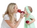 Mother and her child feed each other by red apples