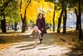 Mother and her child girl playing together on autumn walk in nature outdoors. Royalty Free Stock Photo