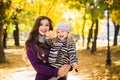 Mother and her child girl playing together on autumn walk in nature outdoors. Royalty Free Stock Photo