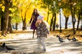 Mother and her child girl playing together on autumn walk in nature outdoors. Royalty Free Stock Photo