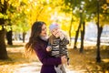 Mother and her child girl playing together on autumn walk in nature outdoors. Royalty Free Stock Photo