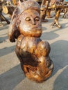 A mother and her child on her breast, made off wood.