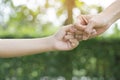 A mother and her child hooking their fingers to make a promise Royalty Free Stock Photo