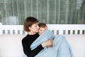 Mother and her child hugging on a swing, embracing with tenderness and care Royalty Free Stock Photo