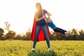 Mother and her child play together . Mom and son in superhero costumes. Mom and baby have fun, smile and hug Royalty Free Stock Photo