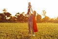 Mother and her child play together . Mom and son in superhero costumes. Mom and baby have fun, smile and hug Royalty Free Stock Photo