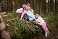 Mother and her child sister girls playing and having fun together on walk in forest outdoors. Happy loving family posing on nature Royalty Free Stock Photo