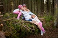 Mother and her child sister girls playing and having fun together on walk in forest outdoors. Happy loving family posing on nature Royalty Free Stock Photo