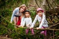 Mother and her child sister girls playing and having fun together on walk in forest outdoors. Happy loving family posing on nature Royalty Free Stock Photo