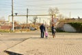 Mother and her children crossing road on way to school