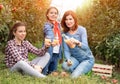 Mother with her children enjoy in natural juice of fruit from her garden