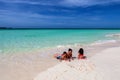 Mother and her children playing on white sandy Cuban beach in Cayo Coco