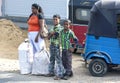 A mother and her children wait on the roadside in Sri Lanka.