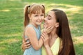 Mother with her cute child in green park