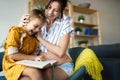 Mother with her cute daughter reading a book at home Royalty Free Stock Photo