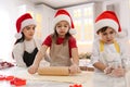 Mother and her cute little children making Christmas cookies in kitchen Royalty Free Stock Photo
