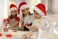 Mother and her cute little children making Christmas cookies in kitchen Royalty Free Stock Photo