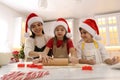 Mother and her cute little children making Christmas cookies in kitchen Royalty Free Stock Photo