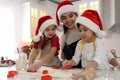 Mother and her cute little children making Christmas cookies in kitchen Royalty Free Stock Photo