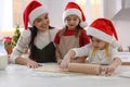 Mother with her cute little children making Christmas cookies in kitchen Royalty Free Stock Photo