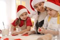 Mother and her cute little children making Christmas cookies in kitchen Royalty Free Stock Photo