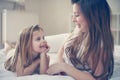 Mother with her cute little daughter lying on bed. Royalty Free Stock Photo