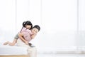 Mother and her daughter child girl playing and hugging on bed in bedroom Royalty Free Stock Photo