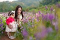 mother and her daughter enjoying Angelonia flower blooming