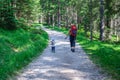 Mother and her daughter hiking in the forest . Travellig adventre and active vacation with children. Dolomites, Italy Royalty Free Stock Photo