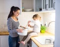 Mother with her daughter in the kitchen cooking together