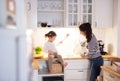 Mother with her daughter in the kitchen cooking together