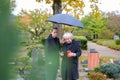 Mother and her daughter-in-law try to light a candle at her son\'s grave